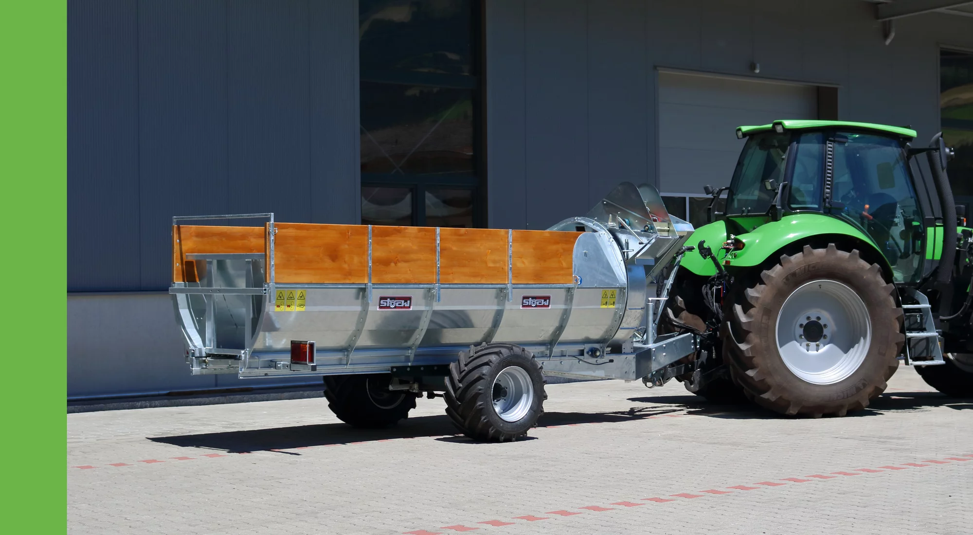 Stöckl trailed side spreader towed by a Deutz Fahr tractor