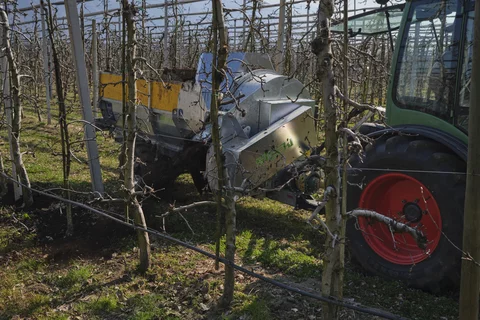 Stöckl trailer-mounted side spreader in use on an apple orchard